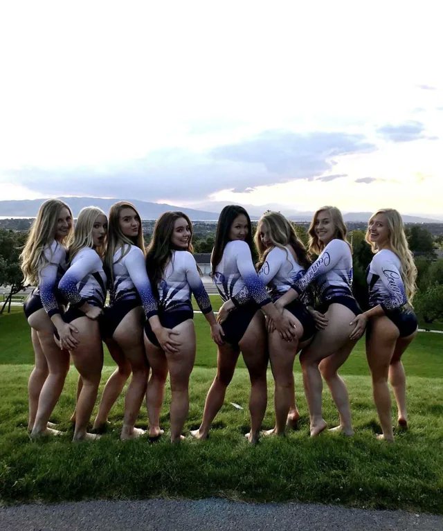 Gymnastics team outside in their leotards having fun